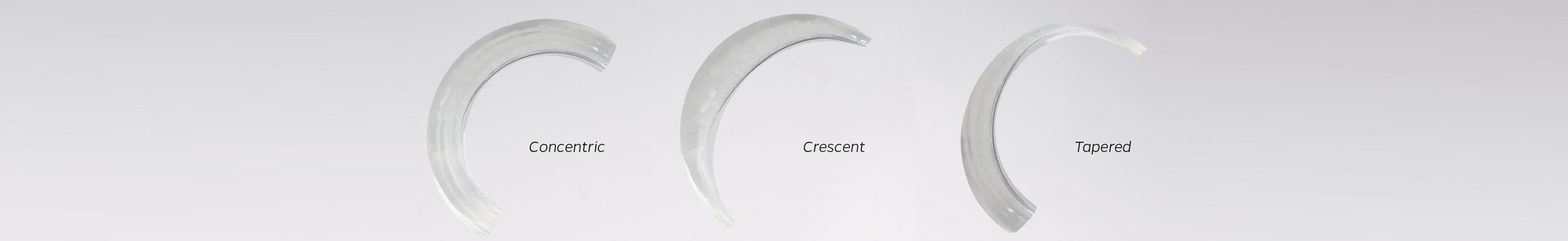 Three clear, curved shapes are arranged side-by-side against a light gray background to illustrate different geometric styles, each accompanied by a text label. The first shape on the left is labeled "Concentric" and shows a smooth, C-shaped curve with a uniform width throughout its length. The middle shape is labeled "Crescent" and features a sweeping arch that is thickest in the center and tapers down to sharp points on both ends. The final shape on the right is labeled "Tapered" and depicts a curved arc that is thick and blunt at one end, steadily narrowing in thickness as it reaches the opposite tip.